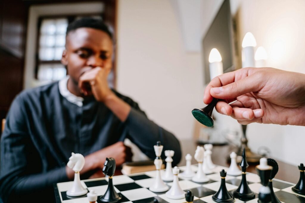 A strategic game of chess unfolds as a player makes a critical move indoors.