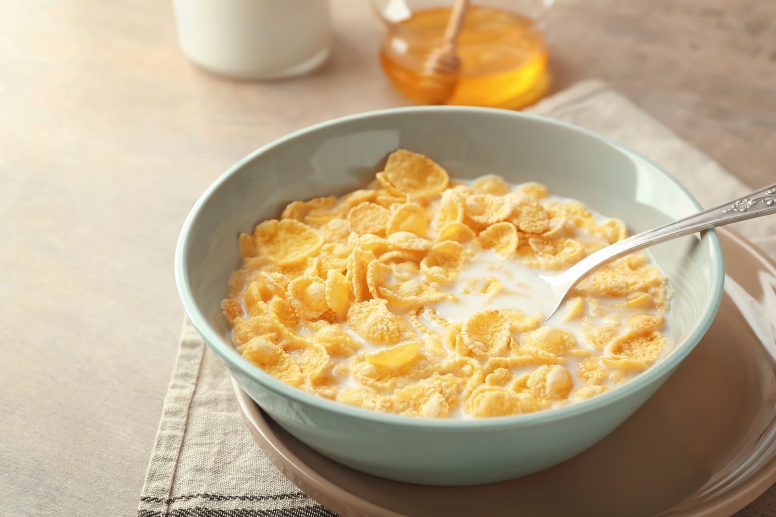 Bowl of cornflakes with milk on a breakfast table