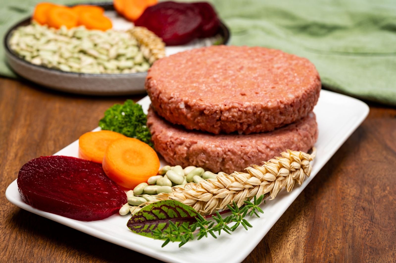 Plant-based protein burgers with vegetables on a wooden board